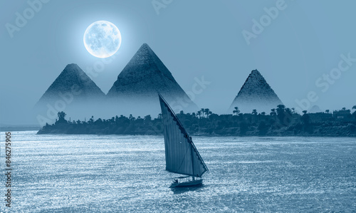 Beautiful Nile scenery with traditional Felluca sailing boat in the Nile on the way to Giza pyramids and The great Sphinx  - Cairo, Egypt   photo