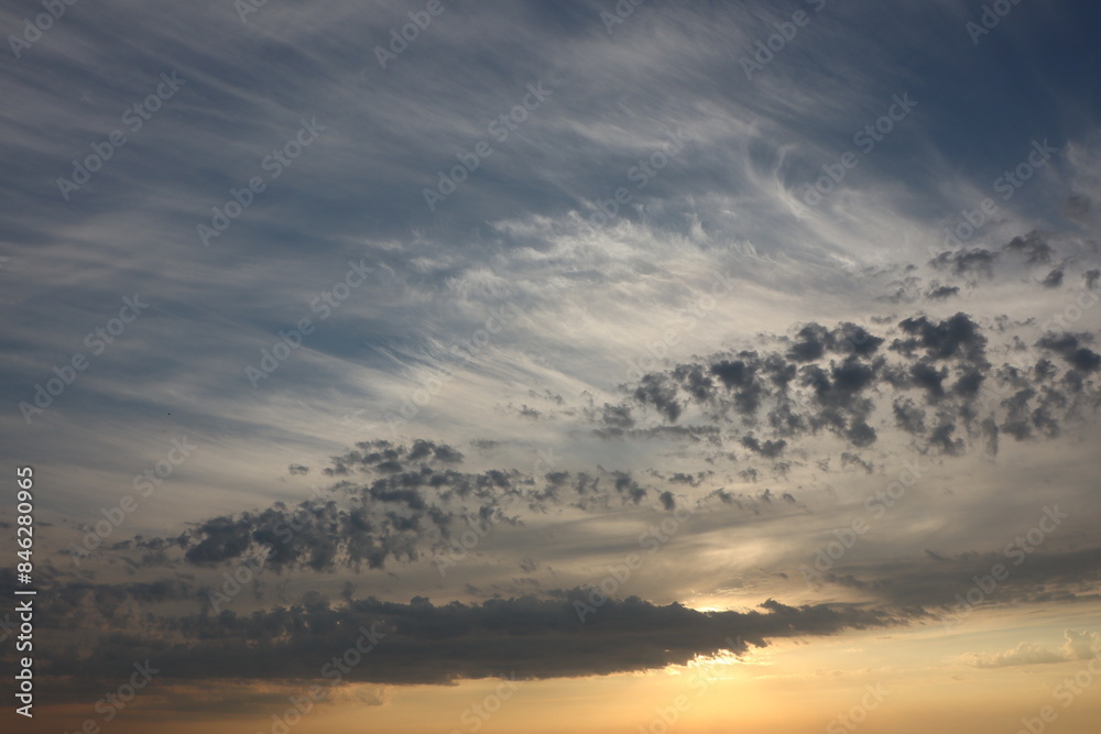 Serene Sunset Sky with Dramatic Clouds. Experience the peaceful beauty of nature at dusk Serene Sunset Sky with Dramatic Clouds. Experience the peaceful beauty of nature at dusk