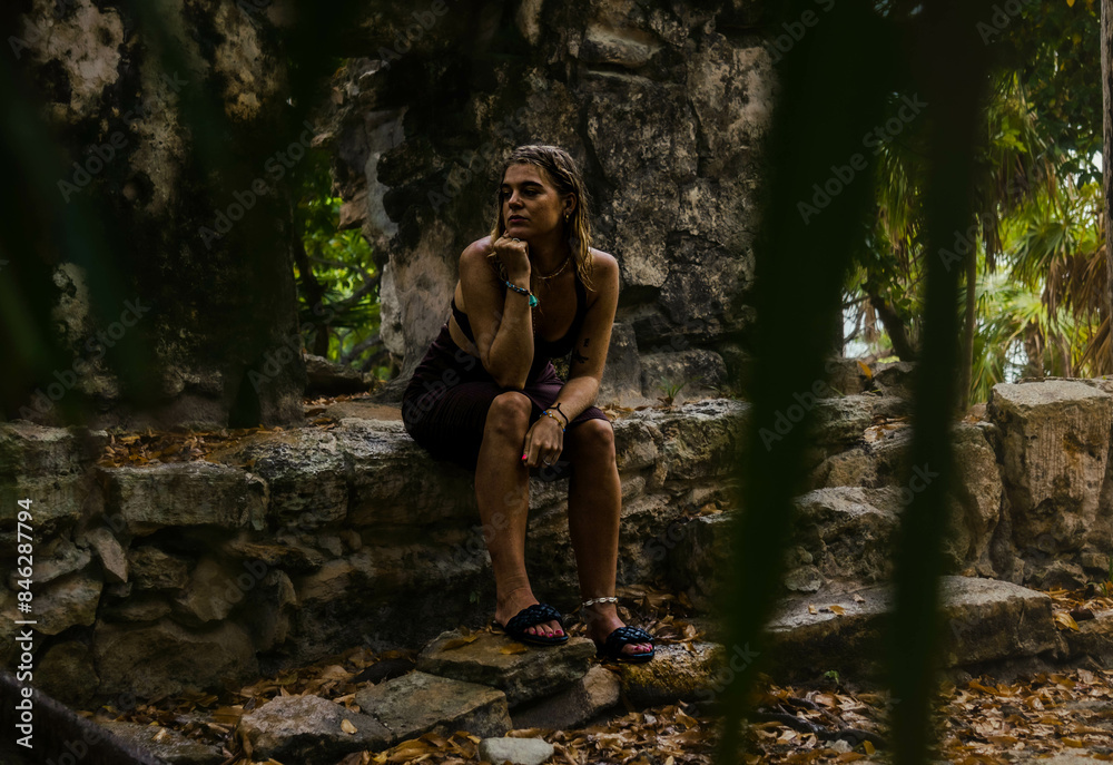 Girl on a dress posing on a Mayan Archeological site in the Jungle of Yucatan Girl on a dress posing on a Mayan Archeological site in the Jungle of Yucatan