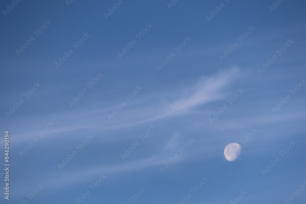 Clear Sky with Moon and Wispy Clouds in the Evening, a serene and tranquil scene Clear Sky with Moon and Wispy Clouds in the Evening, a serene and tranquil scene
