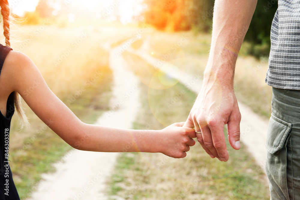 the parent holds the hand of a small child the parent holds the hand of a small child