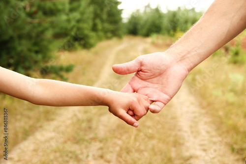 the parent holds the hand of a small child © Kostia
