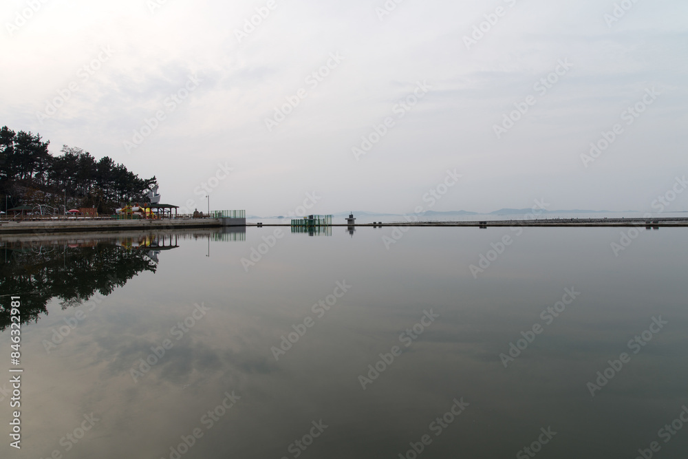 View of the calm lake at the seaside on a cloudy day View of the calm lake at the seaside on a cloudy day