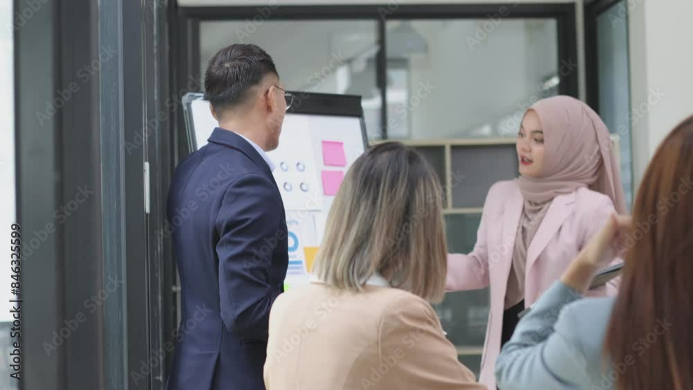 Asian group of people working with documents have financial or marketing charts on a board room table at a business presentation or seminar, business training meeting concept. Asian group of people working with documents have financial or marketing charts on a board room table at a business presentation or seminar, business training meeting concept.