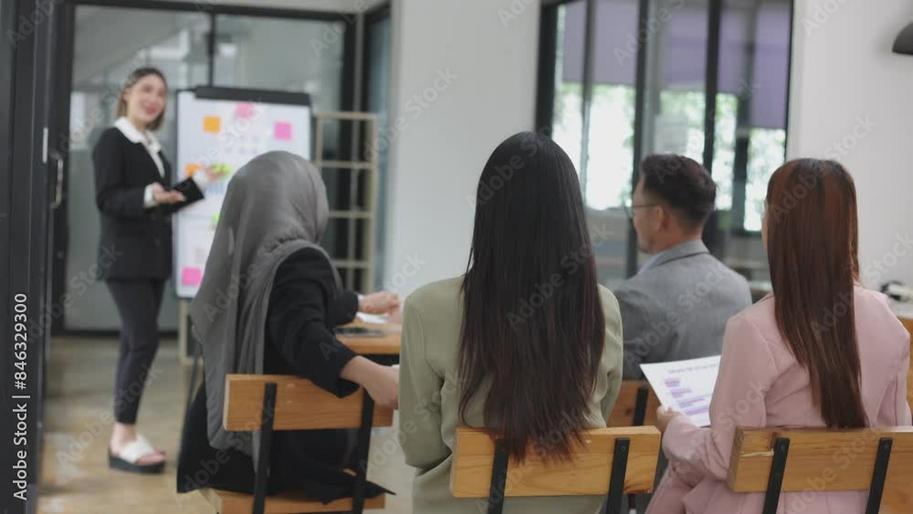Asian group of people working with documents have financial or marketing charts on a board room table at a business presentation or seminar, business training meeting concept. Asian group of people working with documents have financial or marketing charts on a board room table at a business presentation or seminar, business training meeting concept.