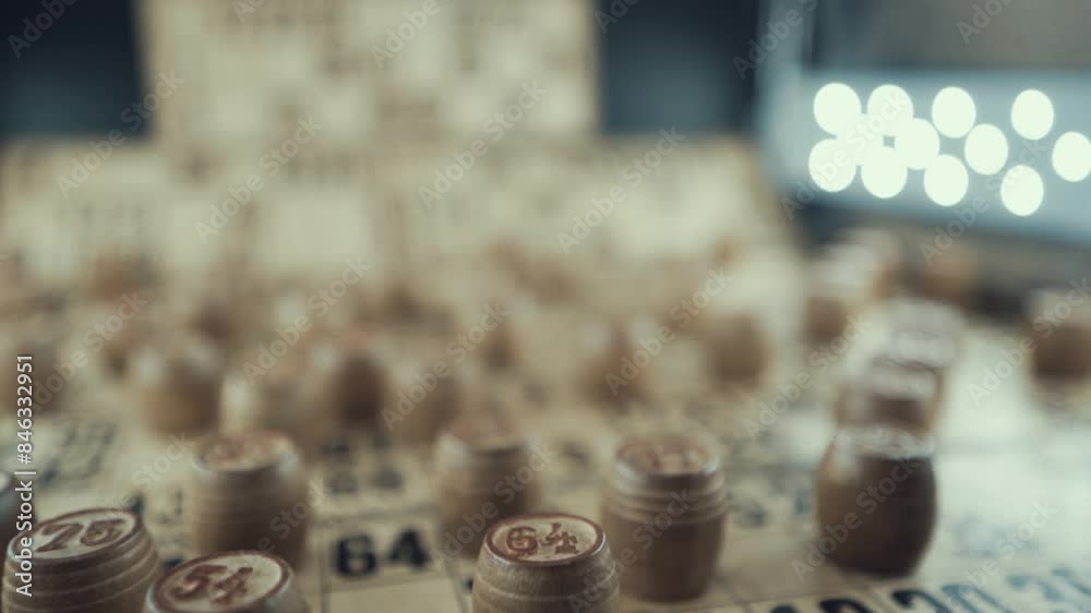 Macro video of a Bingo board, studio lights, 120 fps, slow motion, wooden chip digits, Raw footage, lottery desk game, card numbers, pull back movement Macro video of a Bingo board, studio lights, 120 fps, slow motion, wooden chip digits, Raw footage, lottery desk game, card numbers, pull back movement