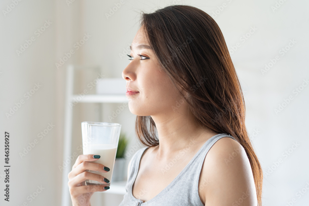 Healthy beautiful asian woman drinking plain fresh milk in the morning. Healthy beautiful asian woman drinking plain fresh milk in the morning.