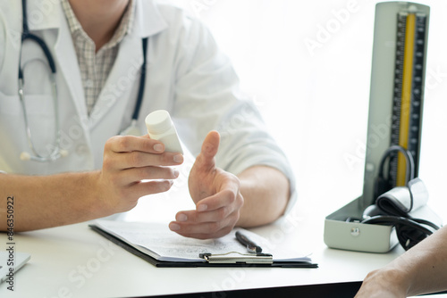 Doctor giving advice about medicine to patient. photo