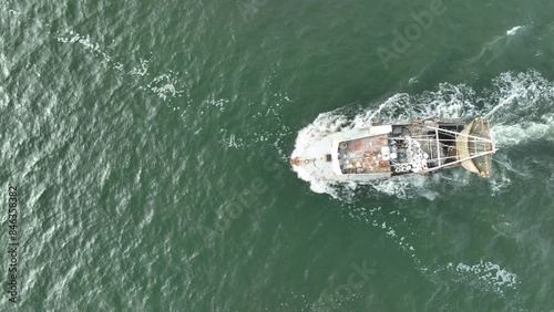 Aerial view of trawler vessel. Fishing boat trauler with sacks full of rapani photo