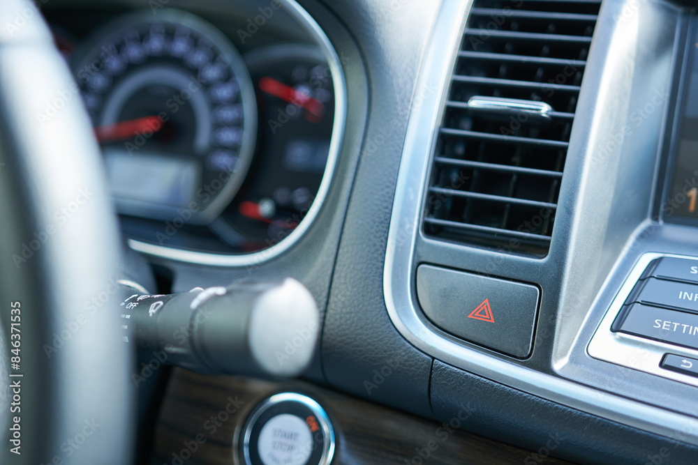Close-up of car dashboard, emergency light button in a modern car, shallow depth of field.