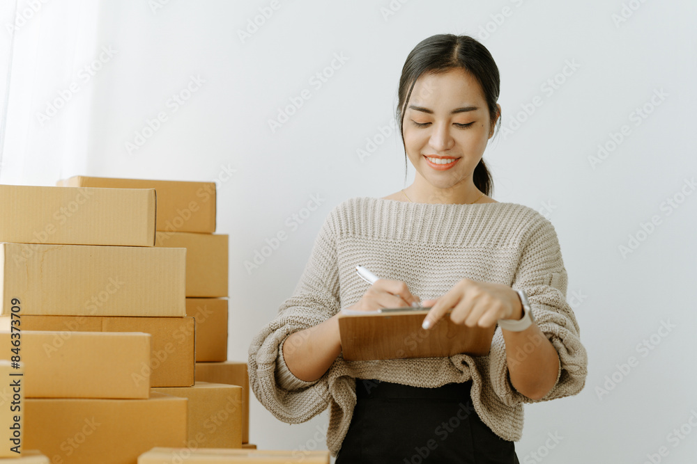 businesswoman start small business and successful SME entrepreneurs asian woman hoding boxs works from home delivering parcels online. SME delivery businesswoman start small business and successful SME entrepreneurs asian woman hoding boxs works from home delivering parcels online. SME delivery