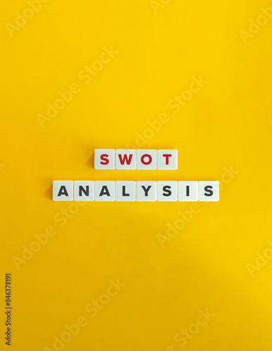 SWOT Analysis Banner. Concept of Identifying Strengths, Weaknesses, Opportunities, and Threats to inform objective setting. Text on Block Letter Tiles on Yellow Background. Minimal Aesthetic. photo