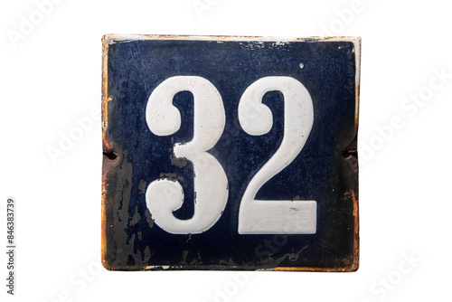 Weathered grunge square metal enameled plate of number of street address with number 32 isolated on white background photo