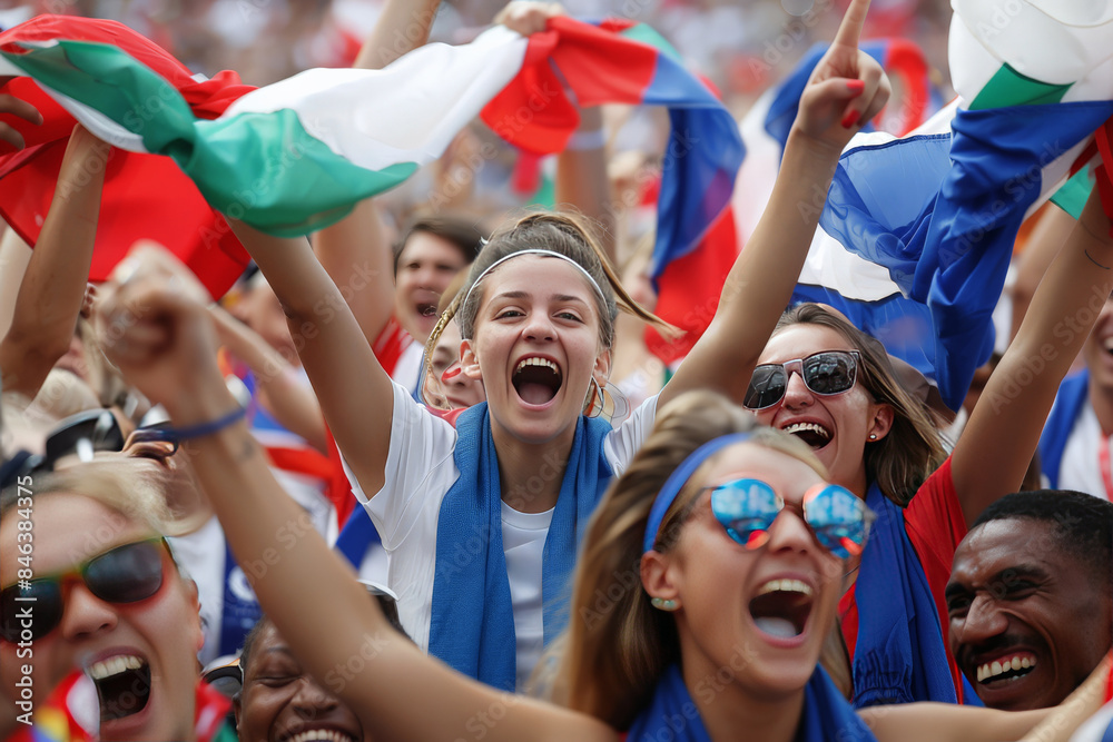 Fototapeta premium A diverse group of soccer fans intensely celebrating a match with national flags aloft
