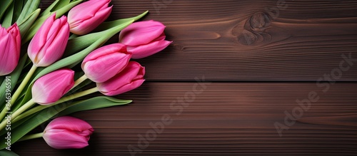 A copy space image featuring pink tulips on a wooden background