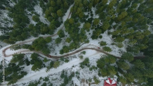 Top view of snow covered Shogran Valley with tall trees in Pakistan. Aerial shot. photo