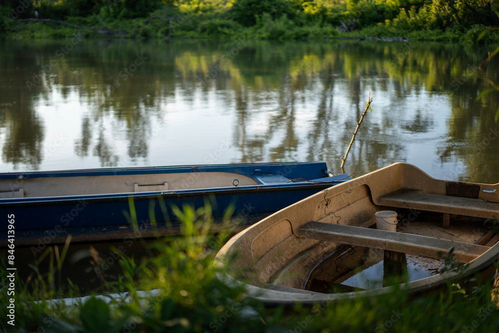 Small fishing boats on the river bank, beautiful summer landscape Small fishing boats on the river bank, beautiful summer landscape