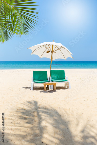 Beach chair with white umbrella on tropical beach  vertical style  summer outdoor day light  it s summer time
