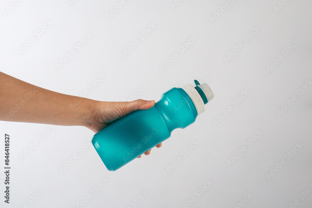 Colourful bottle tumbler and hand isolated on white bakcground Colourful bottle tumbler and hand isolated on white bakcground