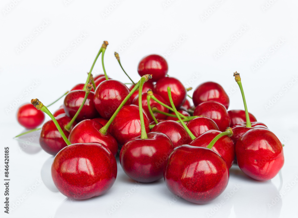 Sweet cherry fruit (Prunus avium) close-up on white background with reflection Sweet cherry fruit (Prunus avium) close-up on white background with reflection