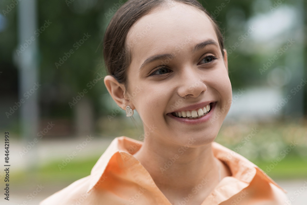 Portrait of attractive caucasian young teen girl in casual clothes. Girl posing in front of the camera while walking outdoors on a warm spring day. Stylish schoolgirl smiling, she is happy. Youth. Portrait of attractive caucasian young teen girl in casual clothes. Girl posing in front of the camera while walking outdoors on a warm spring day. Stylish schoolgirl smiling, she is happy. Youth.