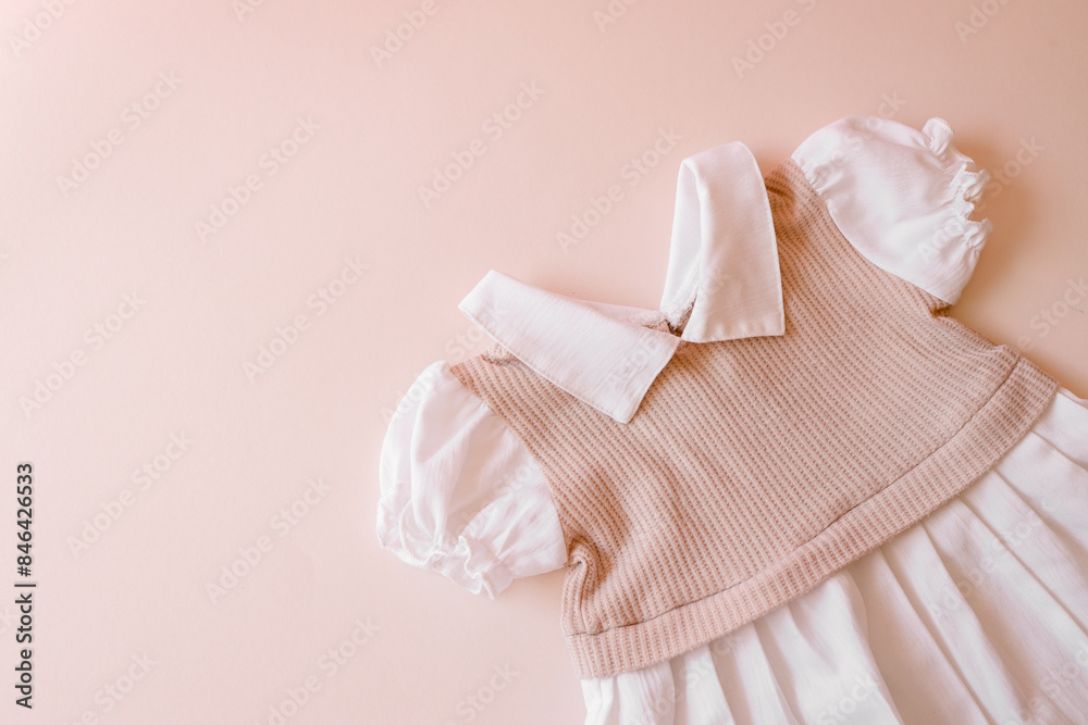 Obraz premium Top view flat lay beige children dress on beige background