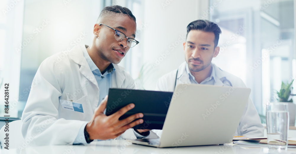 Doctors, meeting and men in hospital with tablet for discussion, treatment plan or diagnosis. Talking, healthcare and medical professionals with laptop for conversation, teamwork or collaboration Doctors, meeting and men in hospital with tablet for discussion, treatment plan or diagnosis. Talking, healthcare and medical professionals with laptop for conversation, teamwork or collaboration