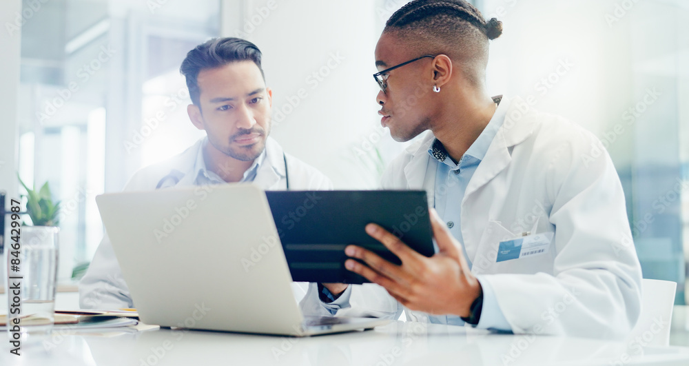 Doctors, meeting and men in hospital with laptop for discussion, treatment plan or diagnosis. Talking, healthcare and medical professionals with technology for conversation, teamwork or collaboration Doctors, meeting and men in hospital with laptop for discussion, treatment plan or diagnosis. Talking, healthcare and medical professionals with technology for conversation, teamwork or collaboration