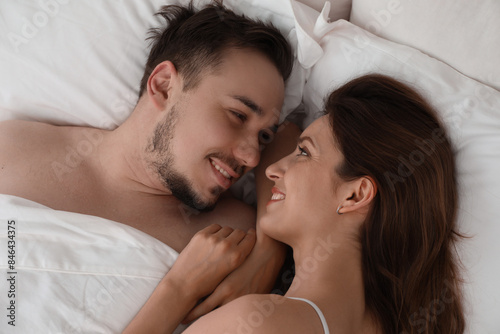 Lovely couple enjoying time together in bed at morning, closeup