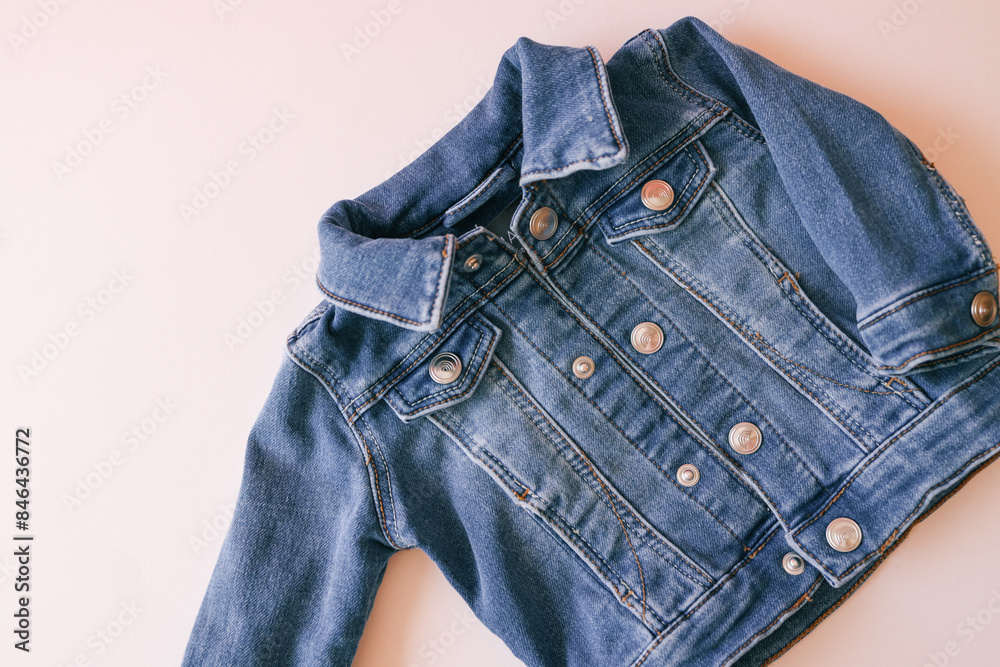 Children's denim jacket on a pink background Children's denim jacket on a pink background