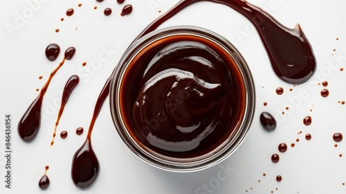 Overhead shot of Hoisin Sauce jar with sauce spilling out slightly, highlighting its rich color and viscosity, isolated background