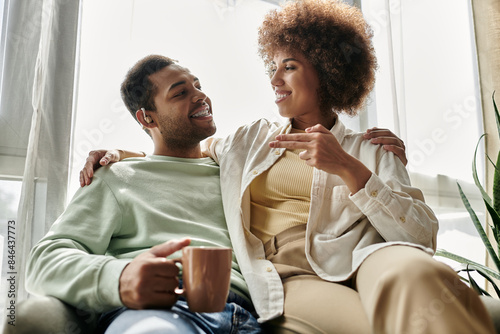 An African American couple shares a loving conversation using sign language at home.