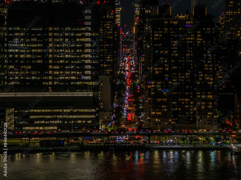 Scenic view of various city lights shining brightly against a dark night sky Scenic view of various city lights shining brightly against a dark night sky