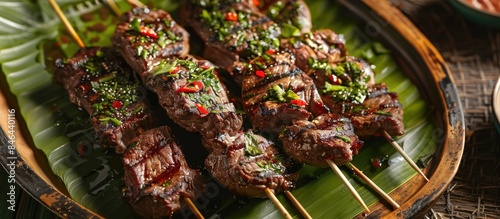 Grilled beef skewers served on a vibrant green platter. photo
