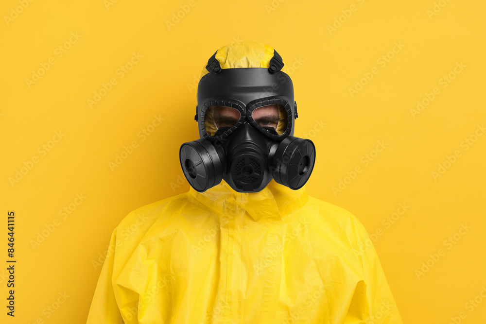 Worker in gas mask on yellow background Worker in gas mask on yellow background