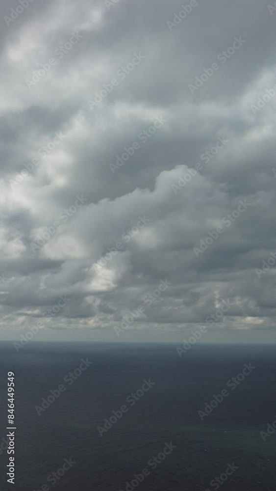 Aerial vertical view. Dramatic moody and gloomy rain clouds over sea. Abstract aerial nature summer ocean sunset sea and sky. Horizon. Vacation, travel and holiday concept. Weather and climate change Aerial vertical view. Dramatic moody and gloomy rain clouds over sea. Abstract aerial nature summer ocean sunset sea and sky. Horizon. Vacation, travel and holiday concept. Weather and climate change