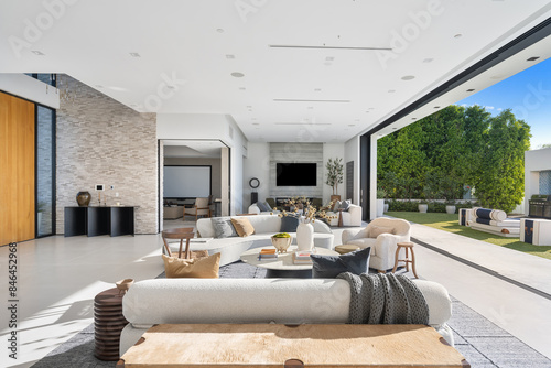 Canvas Print White spacious living room in a luxurious house connected to a large outdoor pat