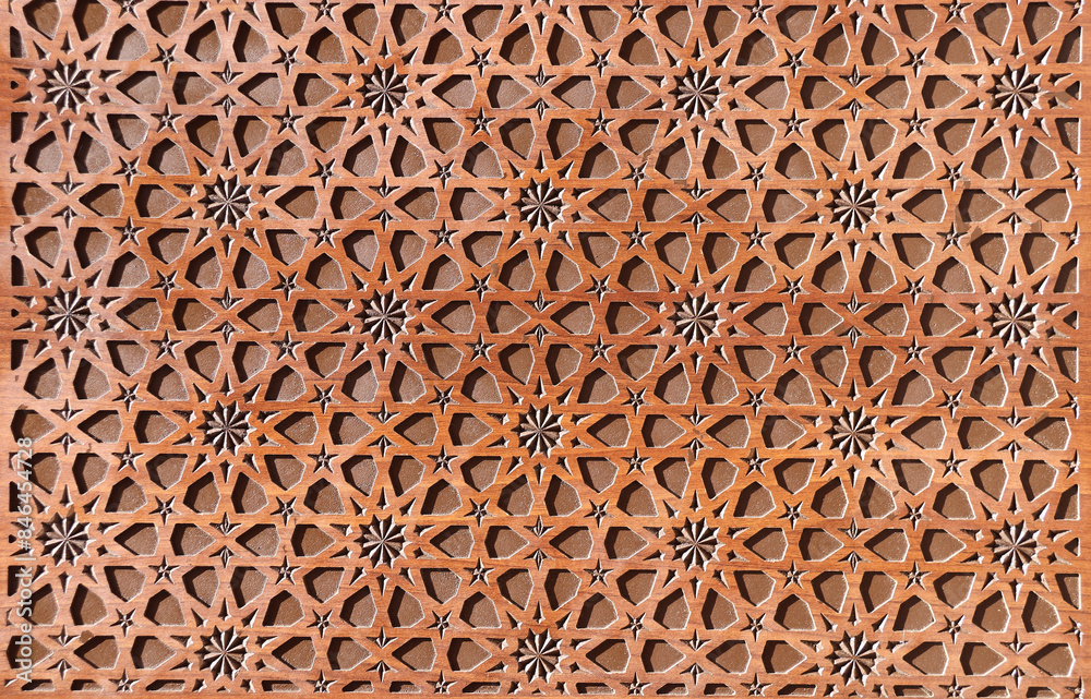 Detail of wooden door with traditional islamic ornament. Wood window shutter with antique iranian geometric pattern. Oriental ornament with artistic carving for wood Detail of wooden door with traditional islamic ornament. Wood window shutter with antique iranian geometric pattern. Oriental ornament with artistic carving for wood