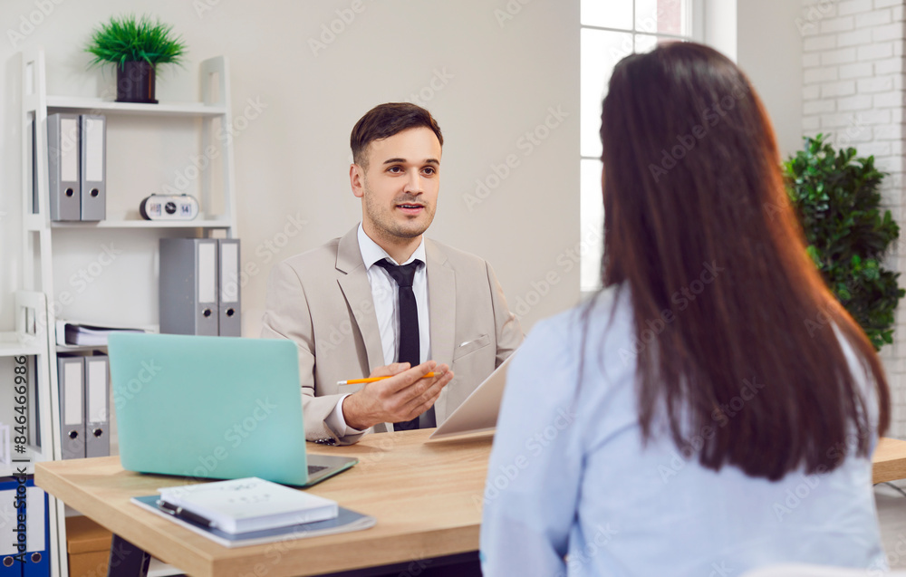 Happy businessman engages in discussion with a client or colleague during a productive office meeting. This scene exemplifies teamwork and collaboration as they work together towards common goals. Happy businessman engages in discussion with a client or colleague during a productive office meeting. This scene exemplifies teamwork and collaboration as they work together towards common goals.