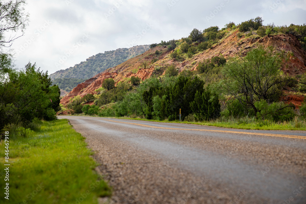 the road is going down the mountain on a cloudy day the road is going down the mountain on a cloudy day