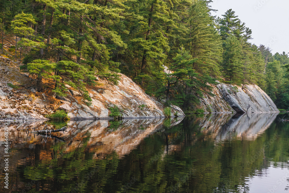 Serene river flowing among picturesque rocks and trees.