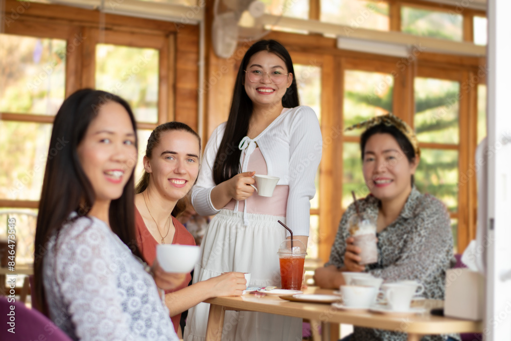 Group of people enjoying soft drinks and dessert at local cafe. Group of people enjoying soft drinks and dessert at local cafe.