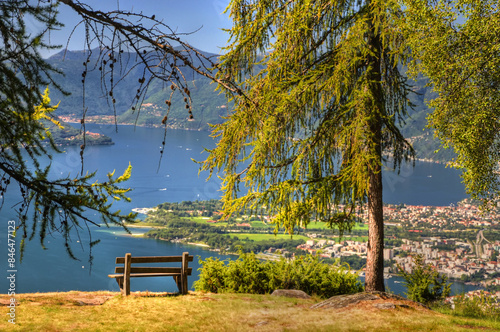 Bench with Panoramic View over an Alpine Lake Maggiore with Mountain in a Sunny Summer Day in Locarno and Ascona, Ticino, Switzerland. photo