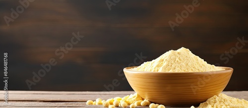 Copy space image of chickpea flour in a white ceramic bowl placed on a wooden table photo