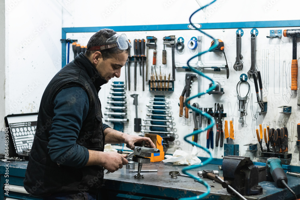 Happy mechanic working. Maintenance of damaged parts in the garage. Maintenance repairs. Repair service concept.