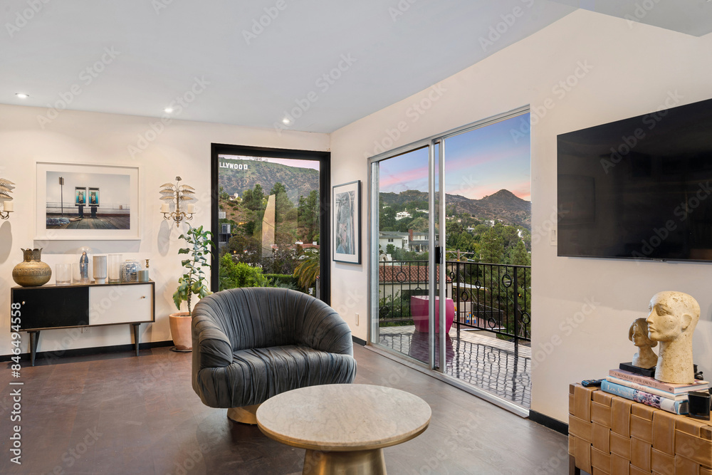 Fototapeta premium Spacious living room with hardwood floors and tall windows. Los Angeles, California