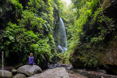 A young woman in Tilos waterfall, La Palma Island, Canary Islands. photo