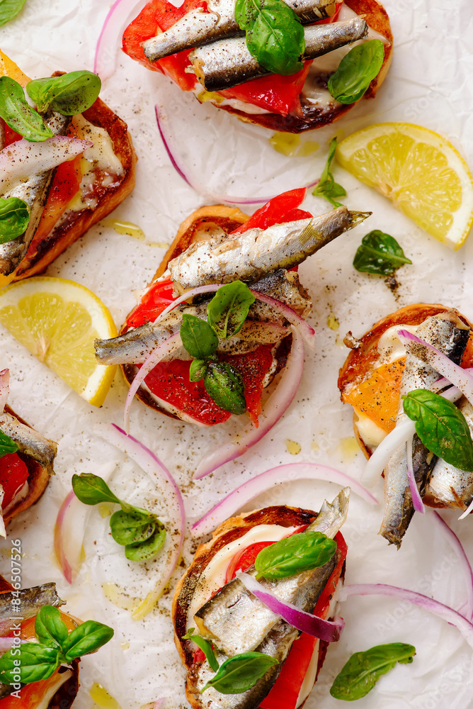 Crostini with sardines, tomatoes, mayonnaise and basi .top veiw Crostini with sardines, tomatoes, mayonnaise and basi .top veiw