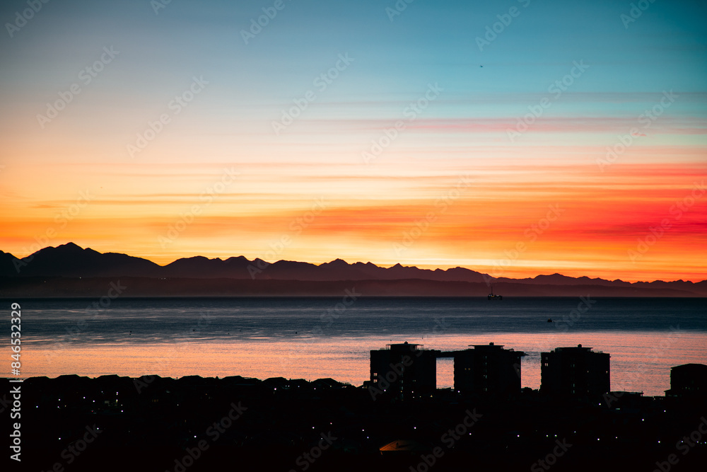 Fototapeta premium sunset over the coastal city