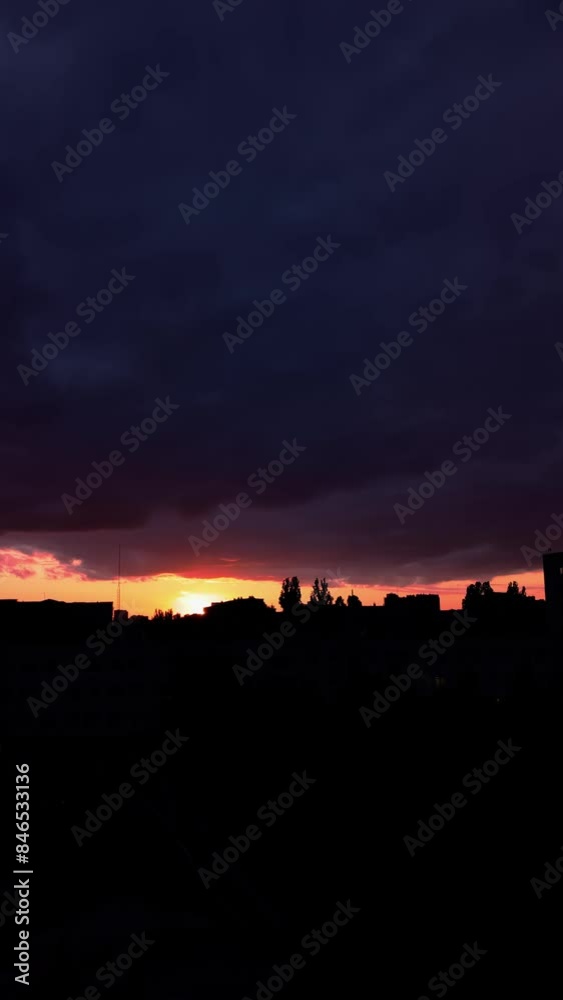 Sunset over buildings and trees in the city. Vertical video Sunset over buildings and trees in the city. Vertical video
